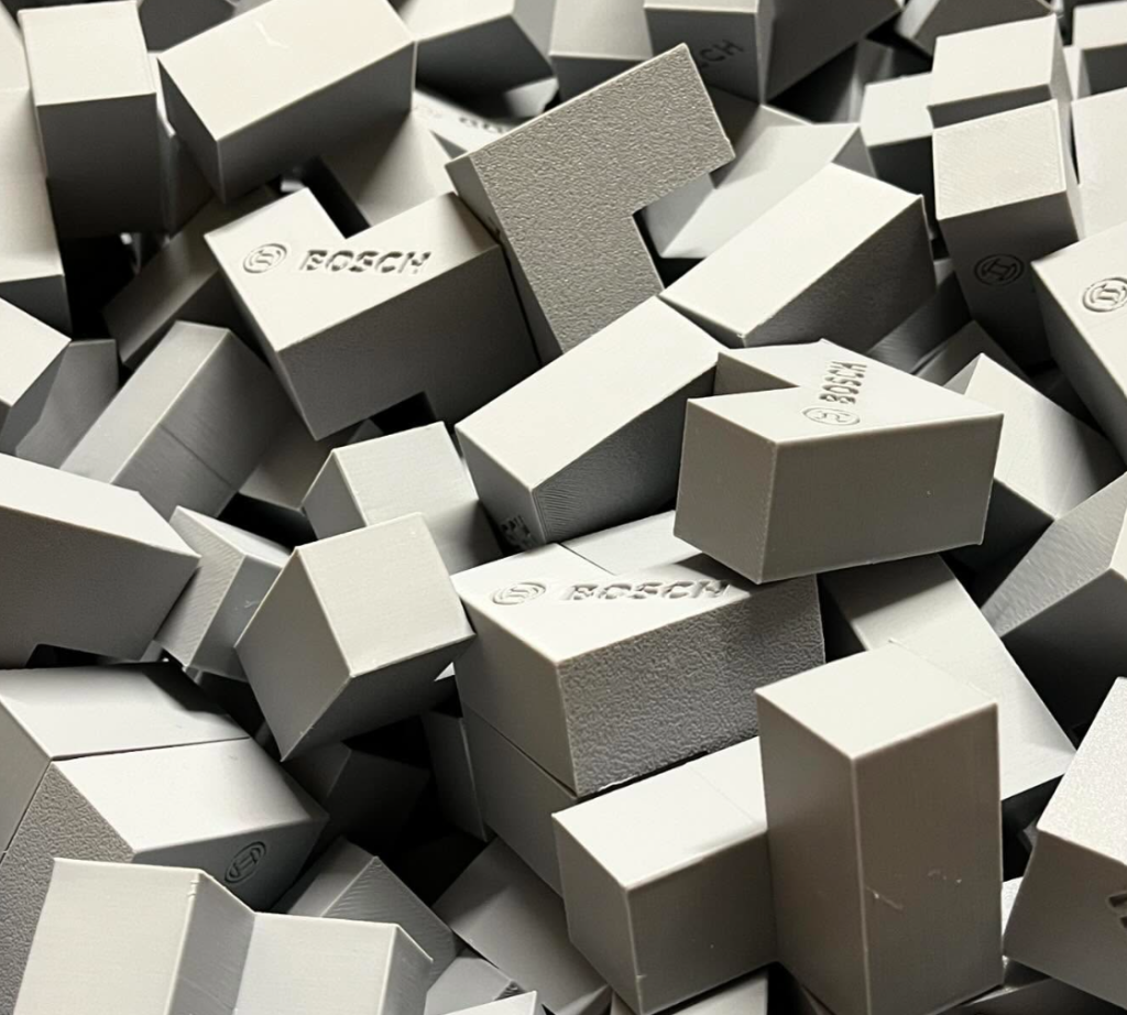 Des milliers de cubes imprimés en FDM en PLA avec le logo Bosch pour une utilisation en salon
