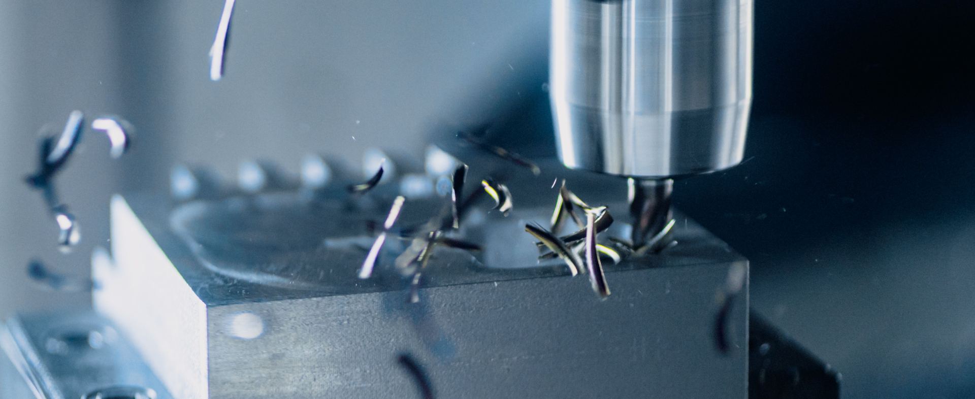 CNC-Fräser im Eingriff, Späne fliegen beim Fräsen eines Metallteils